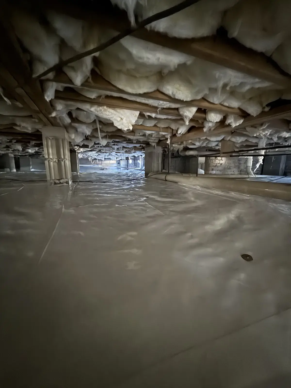 After: clean sealed crawlspace floor with vapor barrier installed
